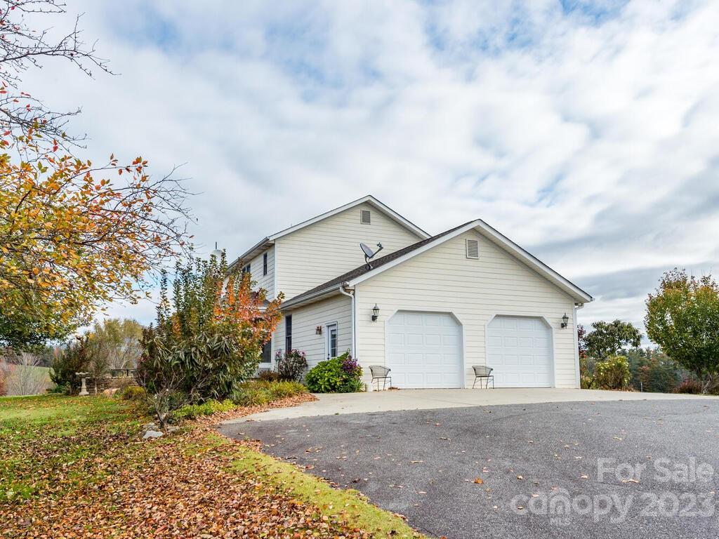 264 Hazel Brook Road Marshall, NC 28753 - Photo 6 of 47 a view of a house with a yard and large trees
