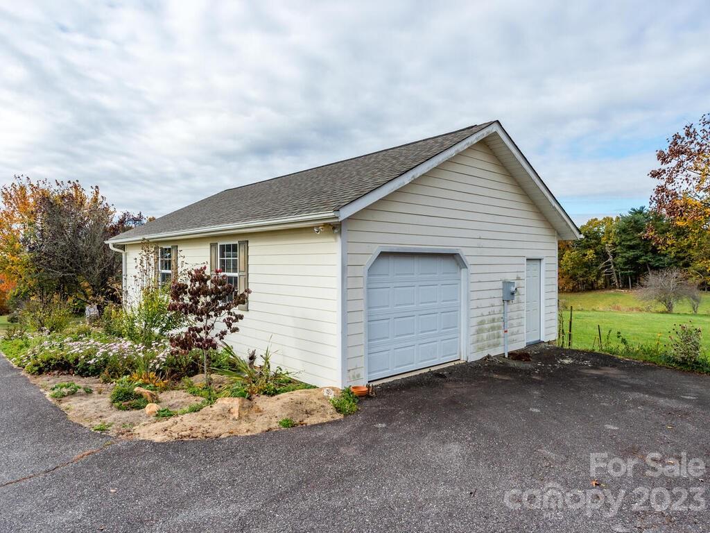 264 Hazel Brook Road Marshall, NC 28753 - Photo 9 of 47 a view of a house with a yard and garage