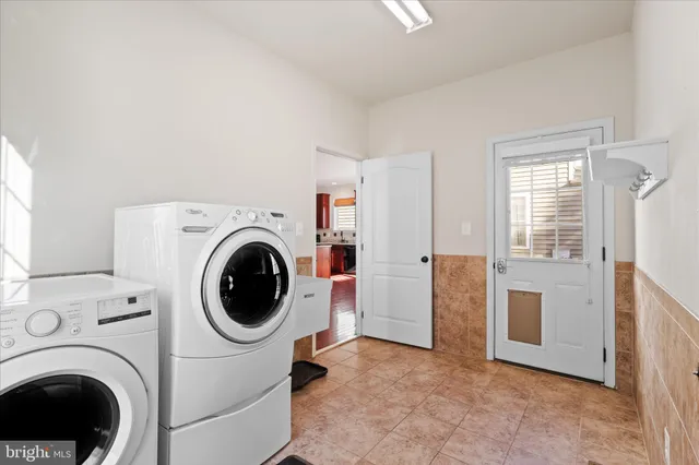 a view of a hallway with washer and dryer