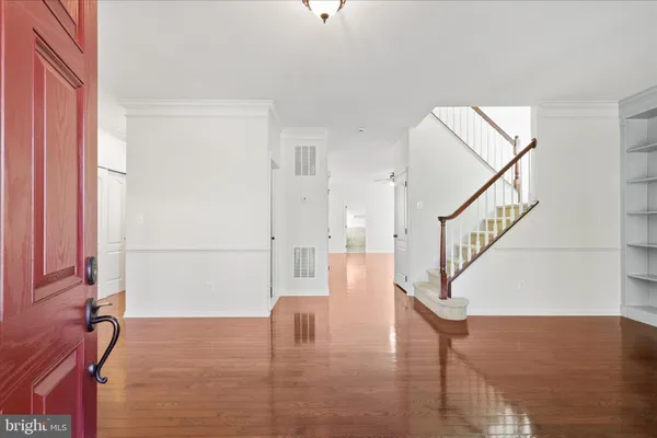 a view of entryway and hall with wooden floor