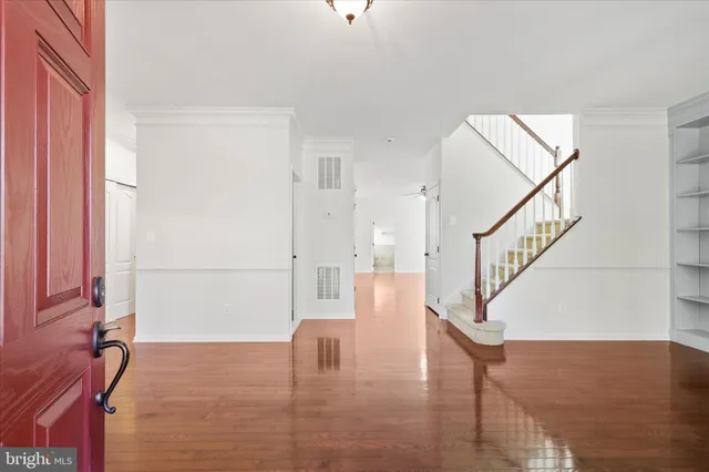 a view of entryway and hall with wooden floor