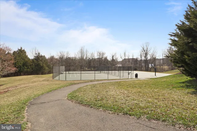 a view of a swimming pool with a yard and wooden fence
