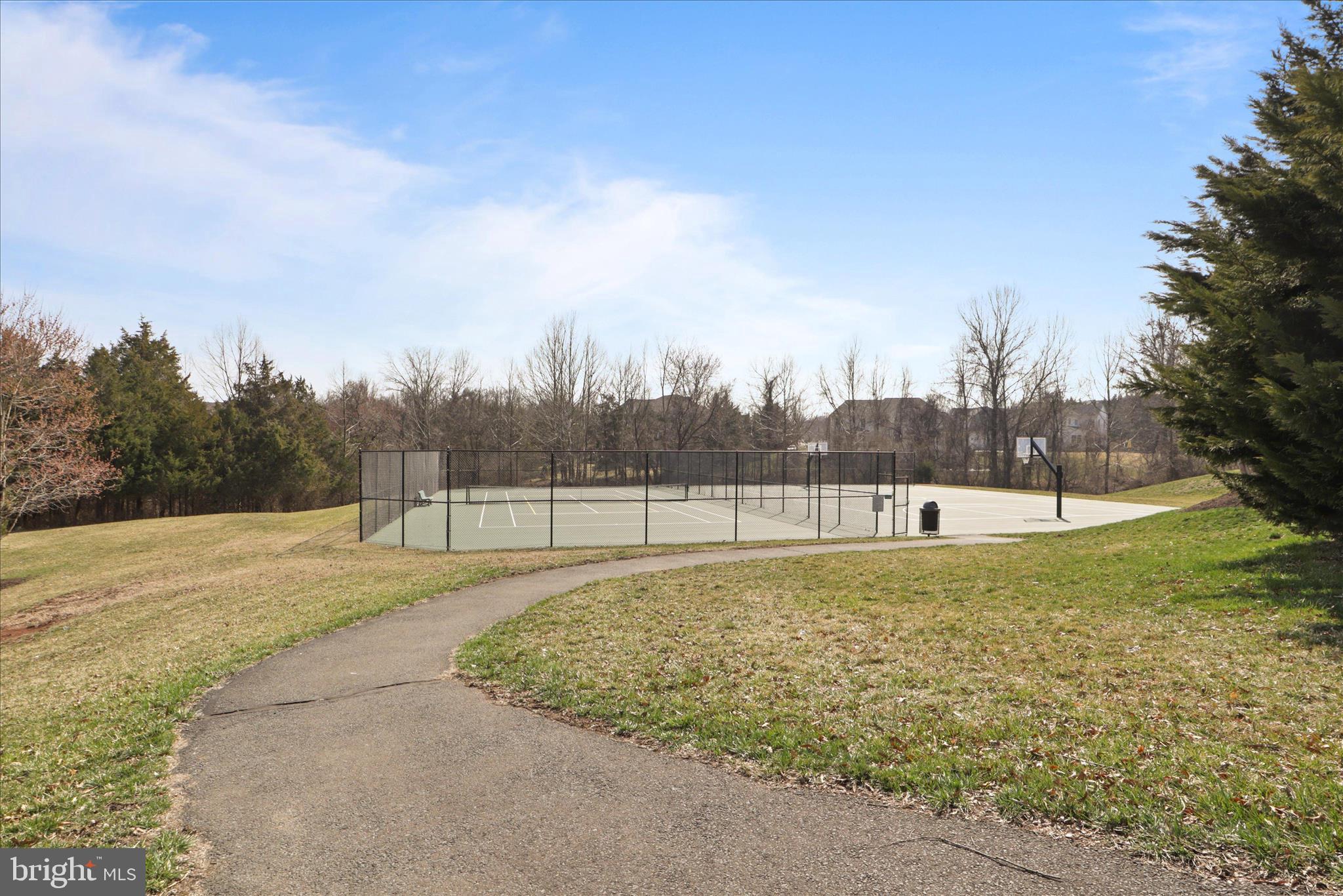15221 Londons Bridge Road Haymarket, VA 20169 - Photo 29 of 43 a view of a swimming pool with a yard and wooden fence