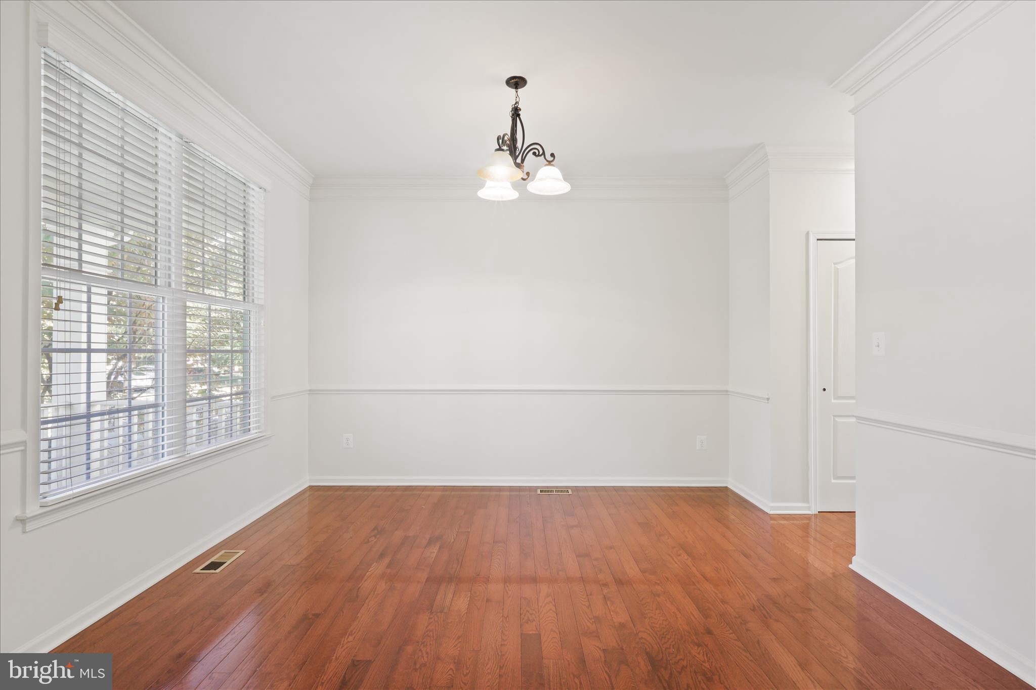 15221 Londons Bridge Road Haymarket, VA 20169 - Photo 3 of 43 an empty room with wooden floor cabinet and windows