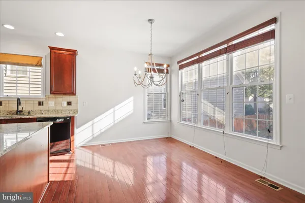 a view of a kitchen with wooden floor and a window