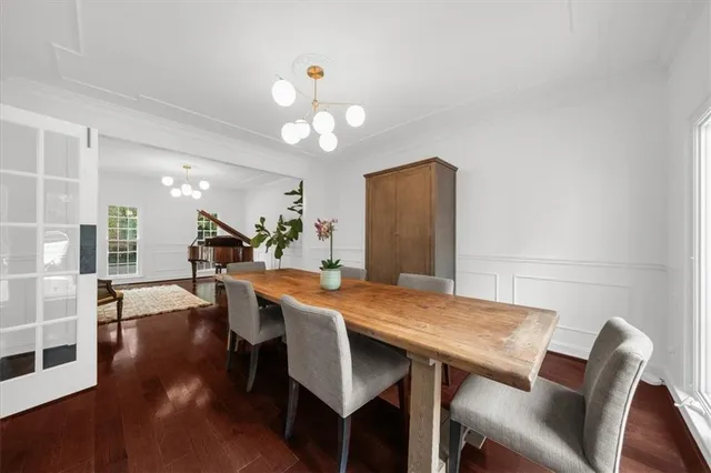 a large white kitchen with stainless steel appliances kitchen island granite countertop a sink stove and refrigerator