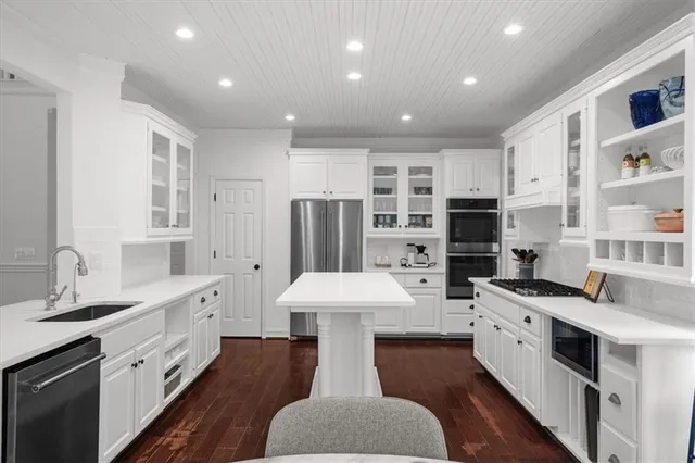 a view of a hallway with wooden floor and stairs