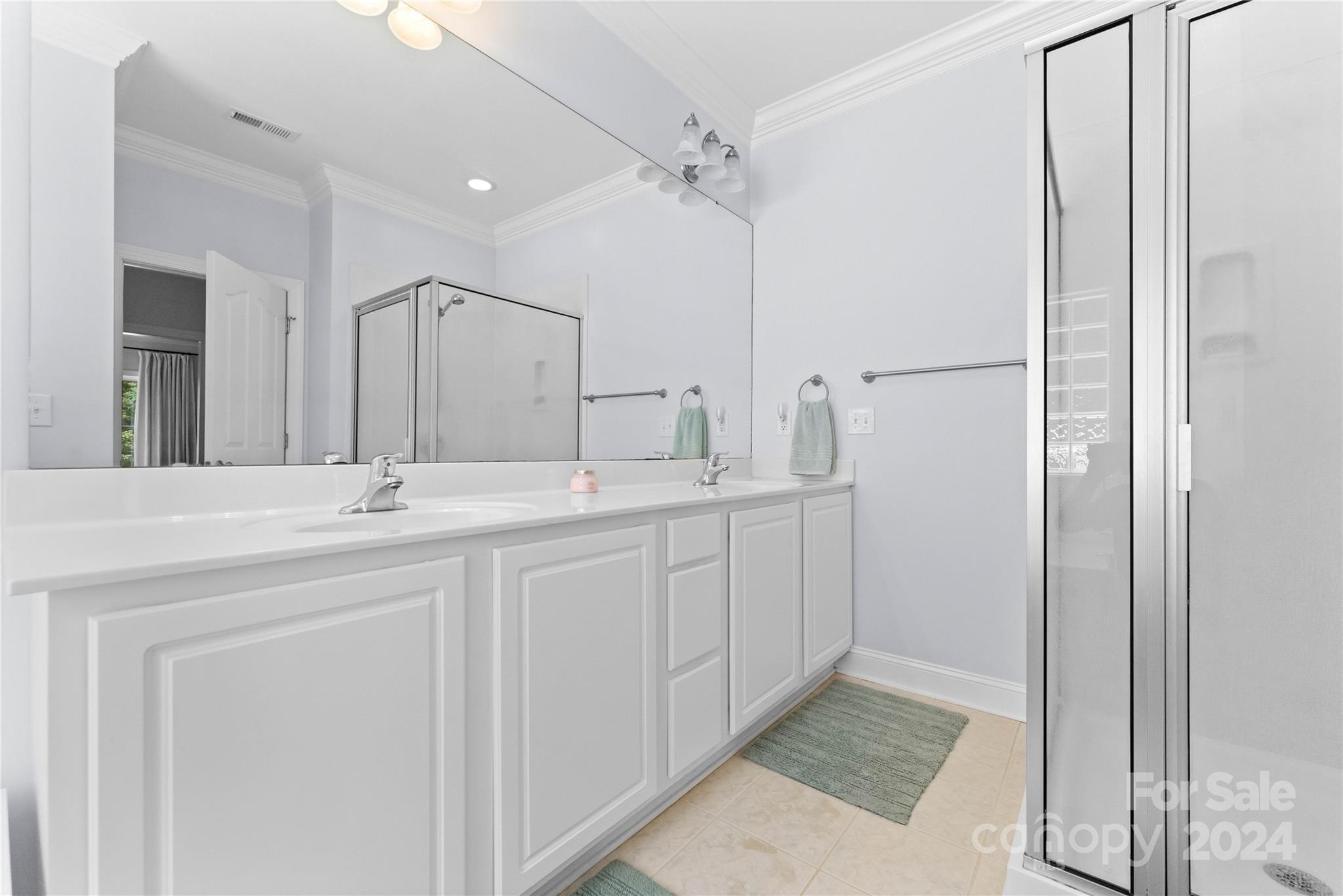 5888 Johnson Road Clover, SC 29710 - Photo 17 of 44 a spacious bathroom with a double vanity sink a mirror and a shower