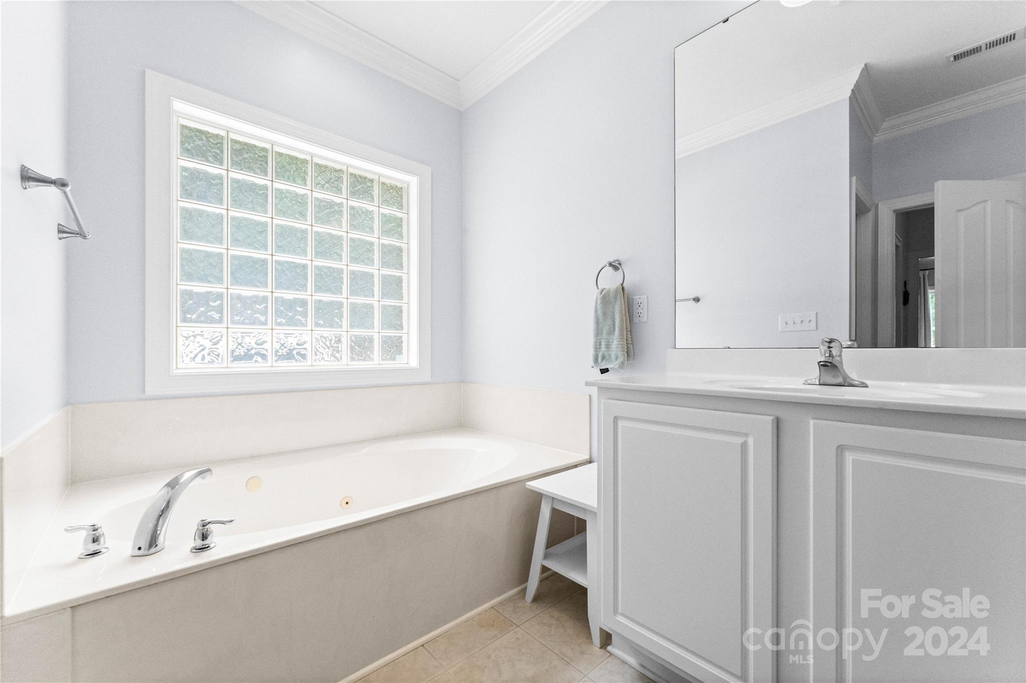 5888 Johnson Road Clover, SC 29710 - Photo 18 of 44 a bathroom with a bathtub a sink a vanity and a window