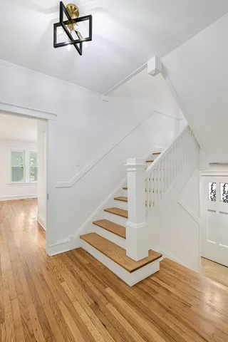 a view of entryway and hall with wooden floor