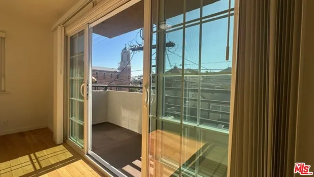 a view of a kitchen with wooden floor and a sink