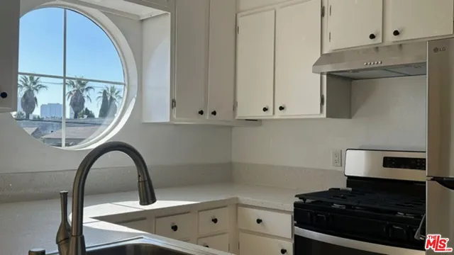 a view of a kitchen with furniture and a window