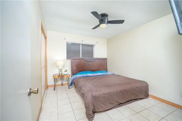 a bedroom with a bed and painting on the wall