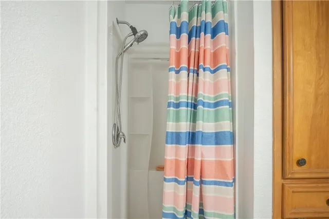 a bathroom with a shower and a curtain