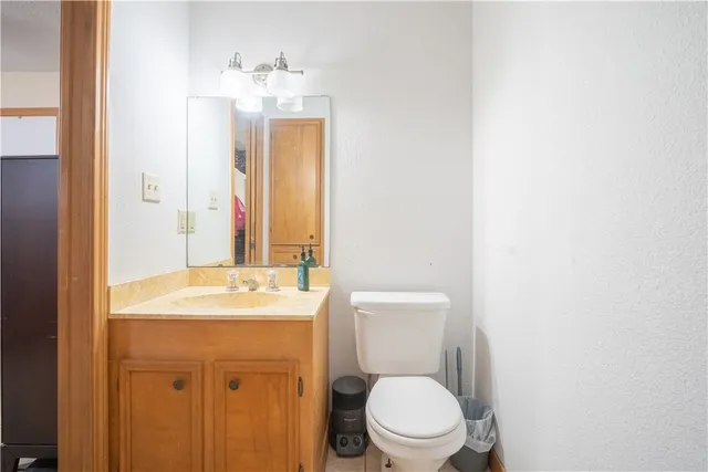 a bathroom with a sink a toilet and mirror