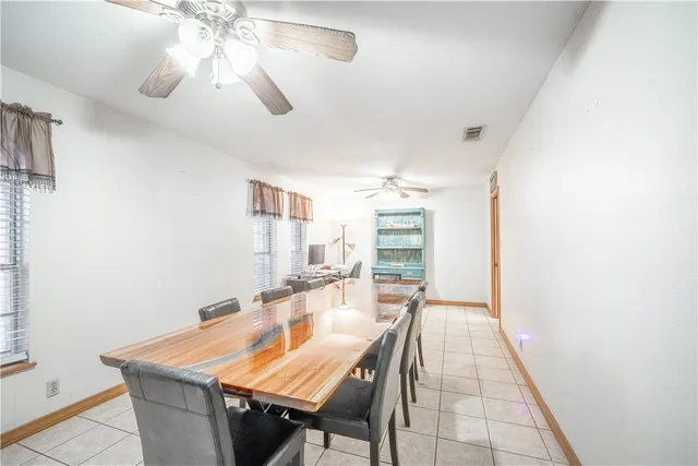 a dining room with a table and chairs