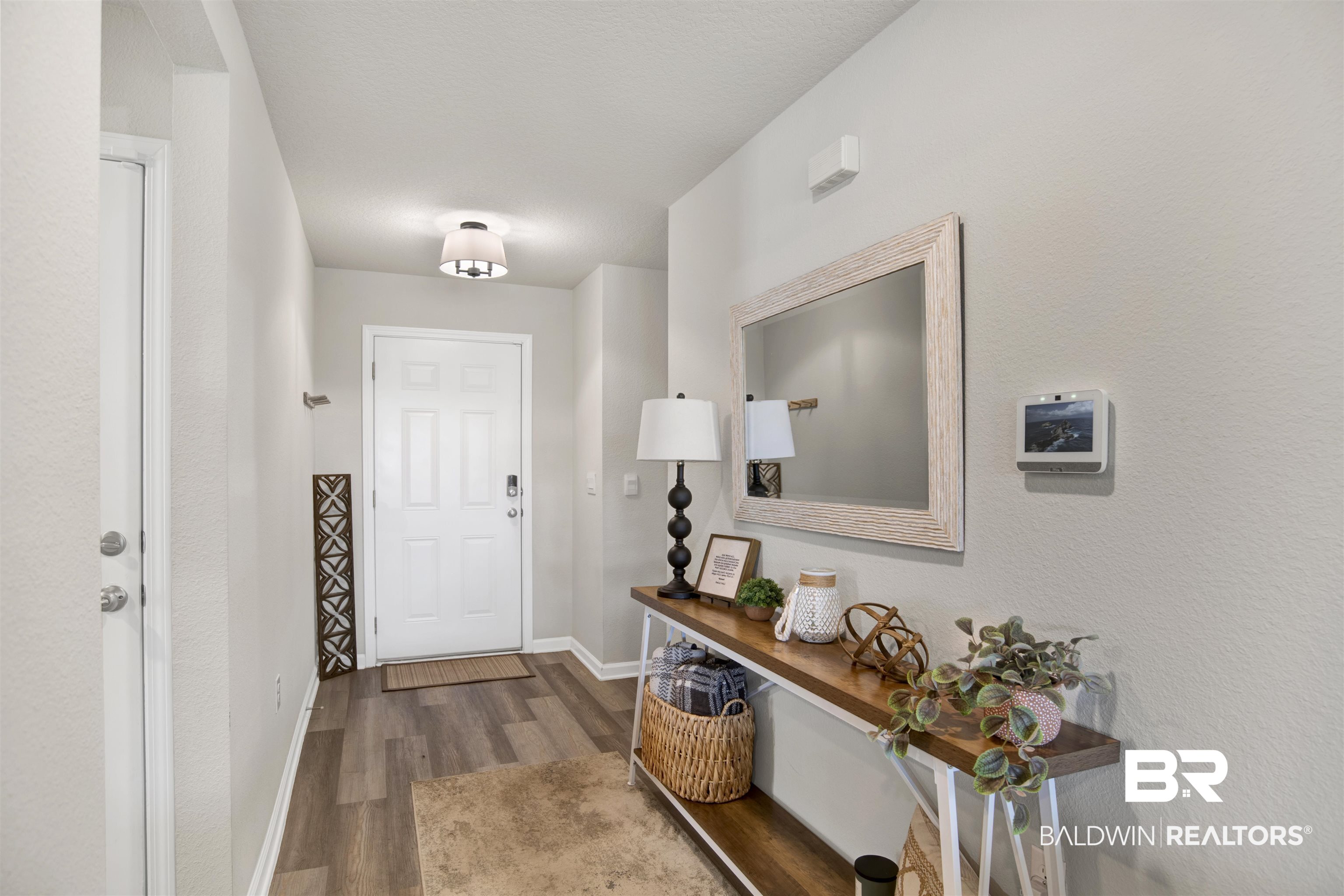 22301 Early Dawn Circle Foley, AL 36535 - Photo 5 of 45 Entryway featuring wood-finish flooring, a white paneled front door, and a flush mount ceiling light fixture