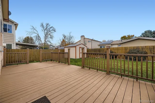 a view of a wooden deck with a yard