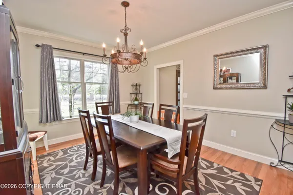 a kitchen with stainless steel appliances granite countertop a stove a sink dishwasher and a refrigerator with wooden floor