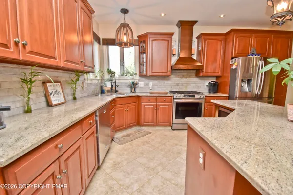a large kitchen with a table and chairs
