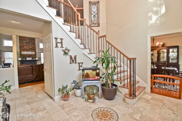 a living room with lots of furniture and a dining table