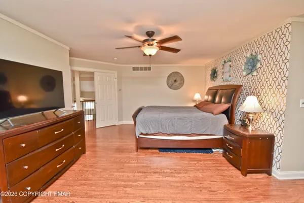 a bedroom with a baby bed baby crib and a dresser