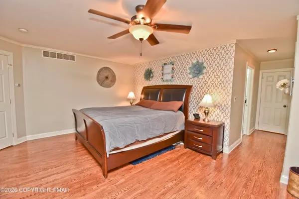 a bedroom with a bed and a dresser