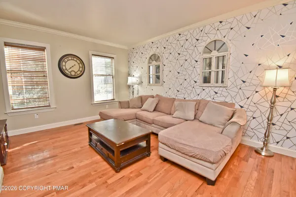 a living room with furniture and wooden floor