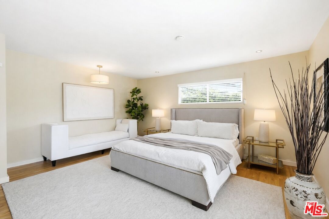 13019 Addison Street Sherman Oaks, CA 91423 - Photo 13 of 28 a spacious bedroom with a bed and a couch