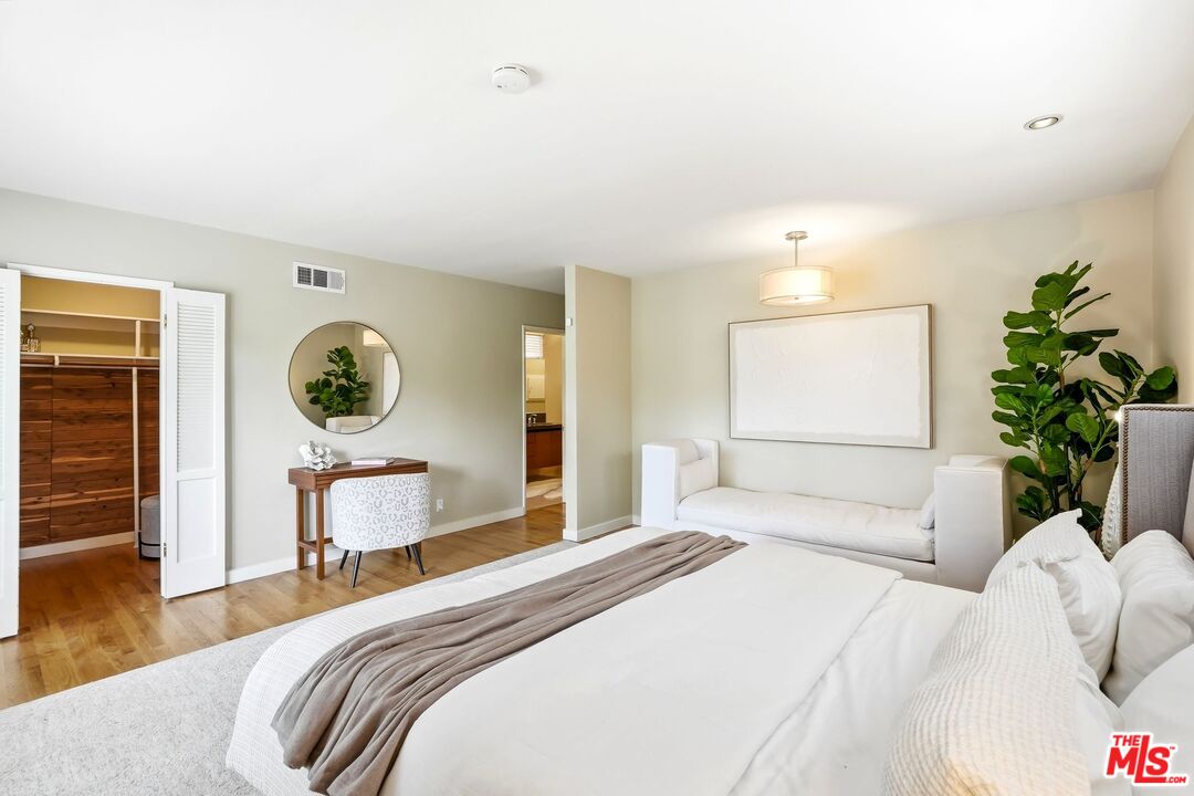 13019 Addison Street Sherman Oaks, CA 91423 - Photo 14 of 28 a bedroom with a bed and a chandelier