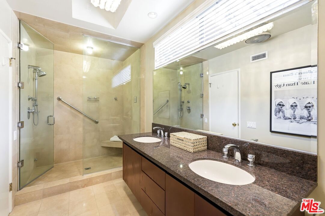 13019 Addison Street Sherman Oaks, CA 91423 - Photo 16 of 28 a bathroom with a granite countertop double vanity sink mirror and shower
