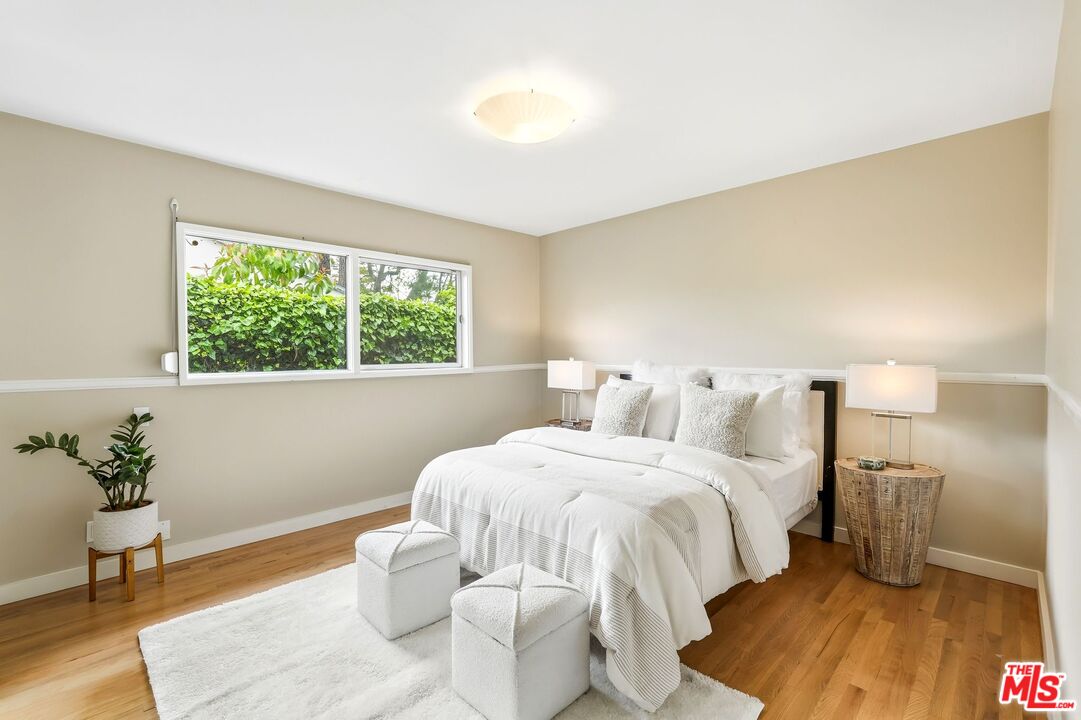 13019 Addison Street Sherman Oaks, CA 91423 - Photo 17 of 28 a bedroom with a bed and a potted plant