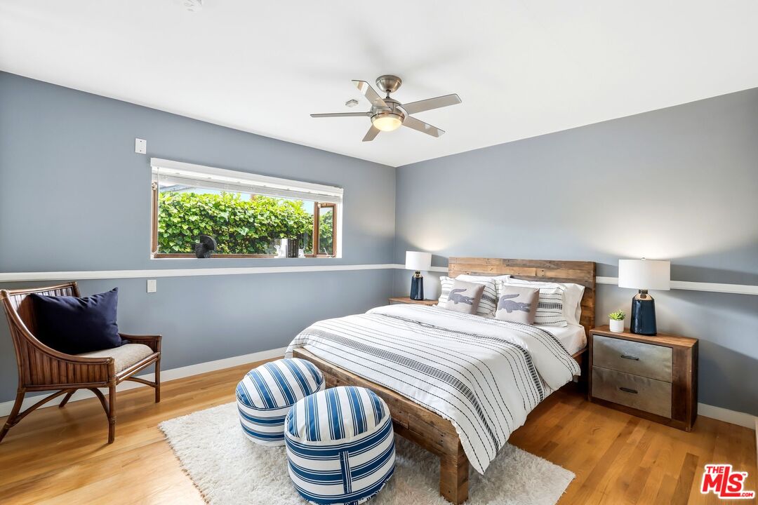 13019 Addison Street Sherman Oaks, CA 91423 - Photo 18 of 28 a bedroom with a bed and a chair