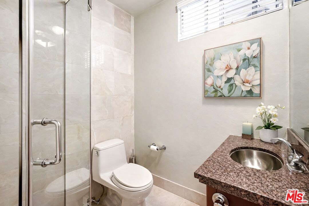 13019 Addison Street Sherman Oaks, CA 91423 - Photo 20 of 28 a bathroom with a toilet and a sink
