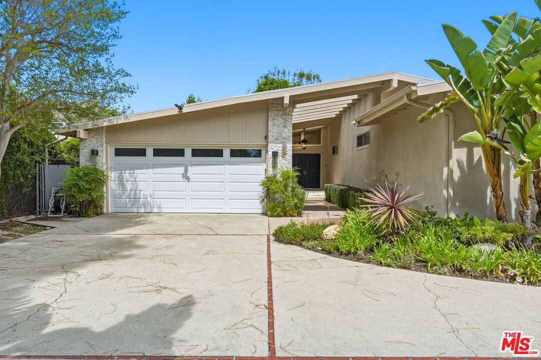 13019 Addison Street Sherman Oaks, CA 91423 - Photo 2 of 28 a view of a house with a yard and garage