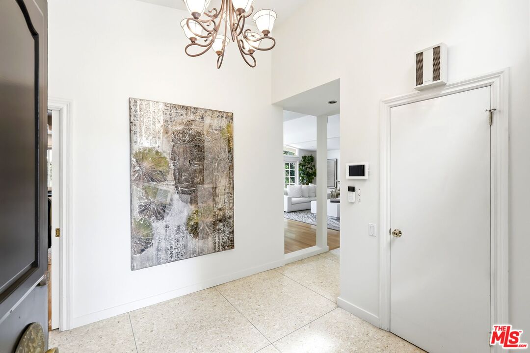 13019 Addison Street Sherman Oaks, CA 91423 - Photo 4 of 28 a view of a hallway to a livingroom with furniture and front door
