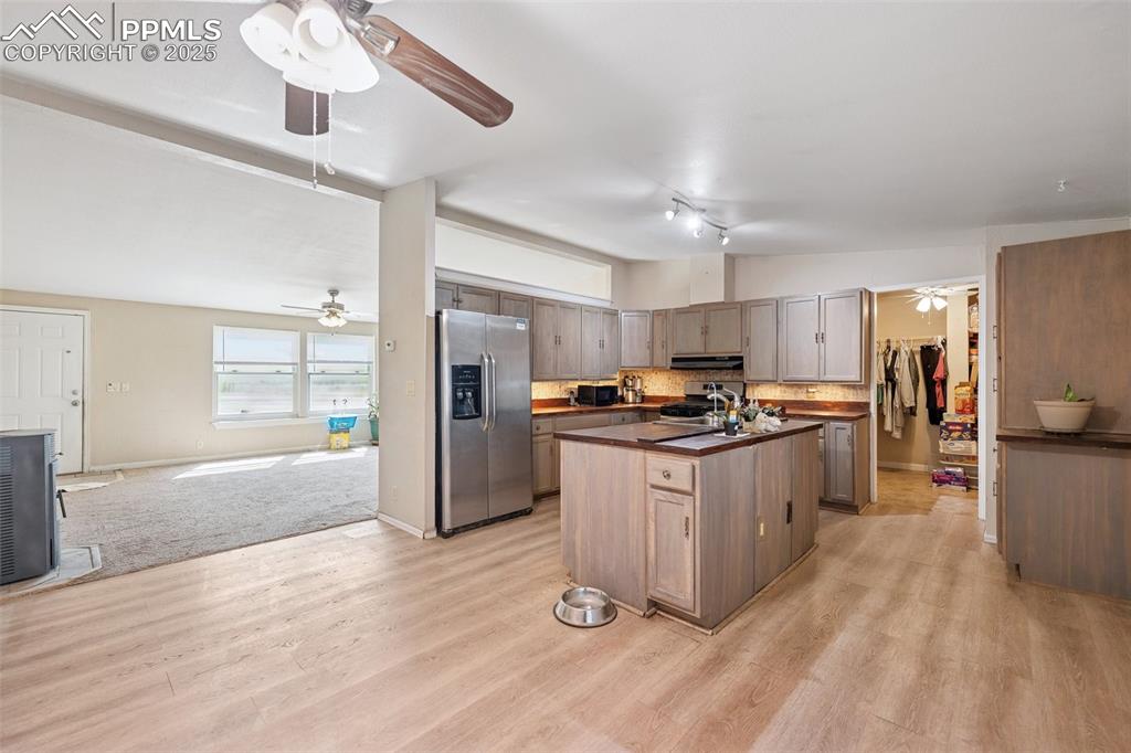 610 Awesome View Yoder, CO 80864 - Photo 30 of 43 a kitchen with stainless steel appliances granite countertop a refrigerator a sink dishwasher a stove and a refrigerator with wooden floor