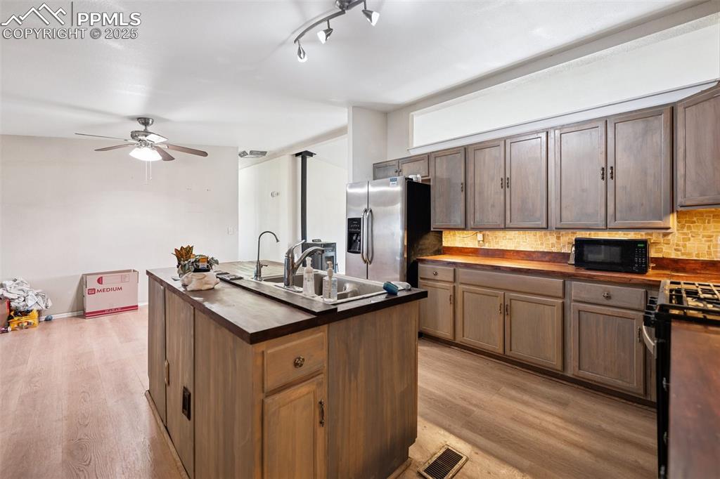 610 Awesome View Yoder, CO 80864 - Photo 31 of 43 a kitchen with stainless steel appliances granite countertop a sink stove and cabinets