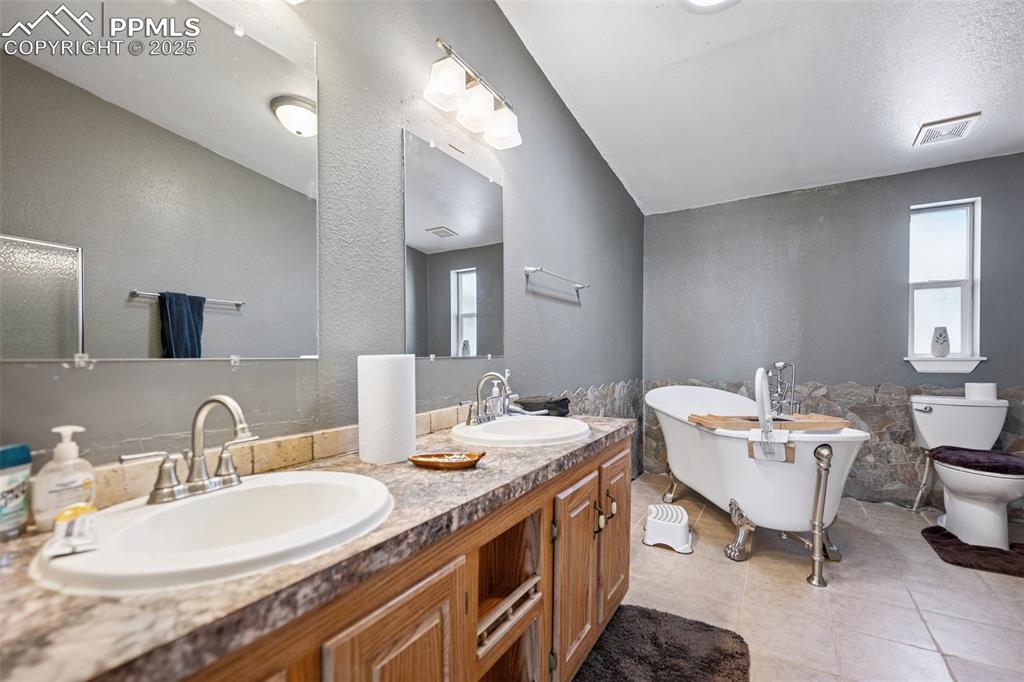 610 Awesome View Yoder, CO 80864 - Photo 34 of 43 a bathroom with a double vanity sink mirror and a toilet