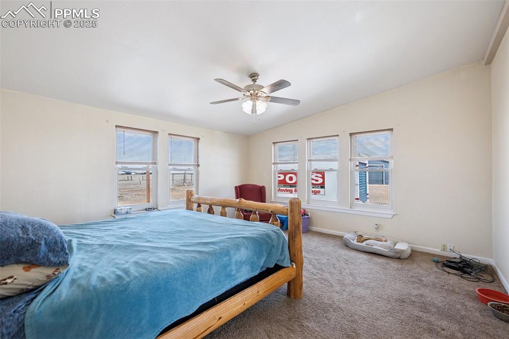 610 Awesome View Yoder, CO 80864 - Photo 42 of 43 a bedroom with a bed and a chandelier