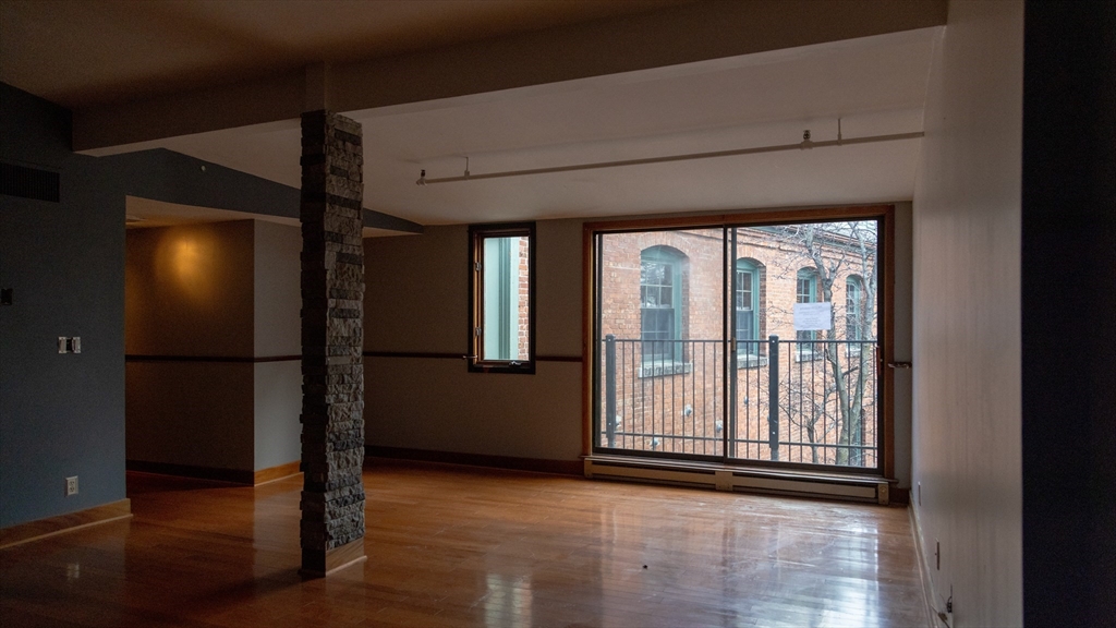 555 South Main Street, Unit 321 Providence, RI 02903 - Photo 11 of 22 a view of empty room with wooden floor and fan