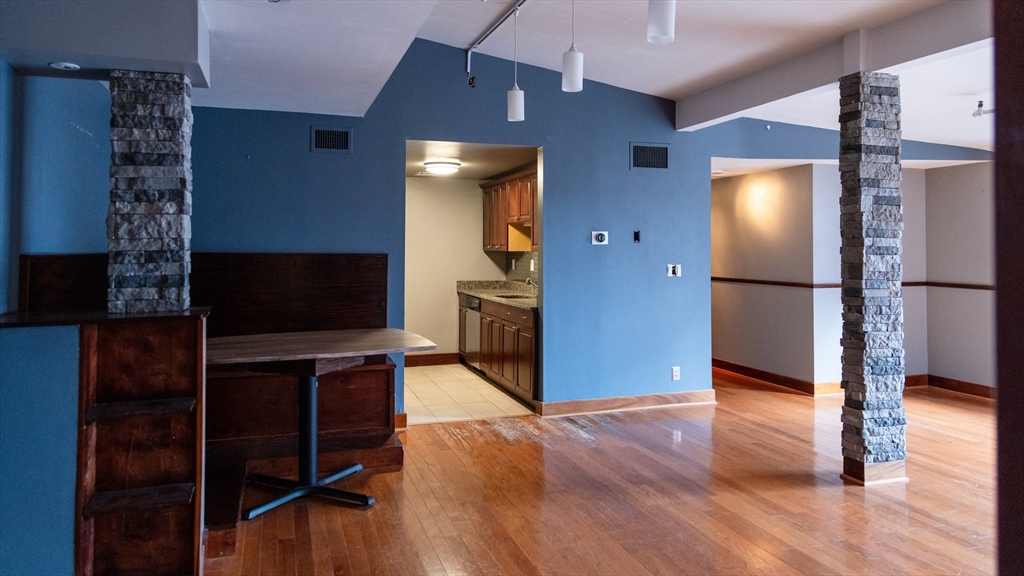 555 South Main Street, Unit 321 Providence, RI 02903 - Photo 17 of 22 a view of a livingroom with wooden floor and a refrigerator