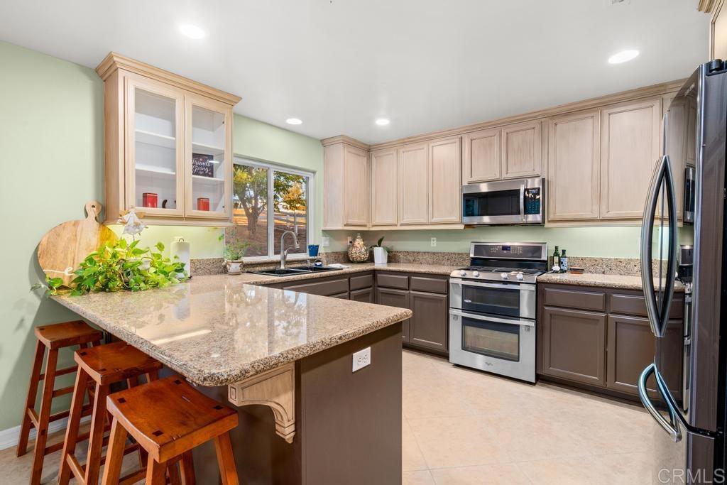 2043 Pamo Road Ramona, CA 92065 - Photo 11 of 63 a kitchen with stainless steel appliances granite countertop a stove refrigerator sink and microwave