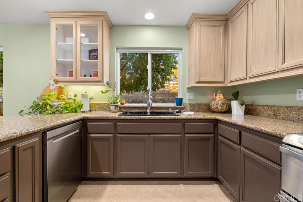 2043 Pamo Road Ramona, CA 92065 - Photo 12 of 63 a kitchen with stainless steel appliances granite countertop a sink and a window