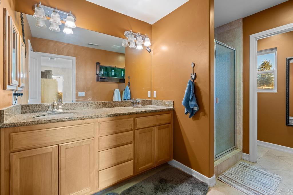 2043 Pamo Road Ramona, CA 92065 - Photo 20 of 63 a bathroom with a double vanity sink and mirror
