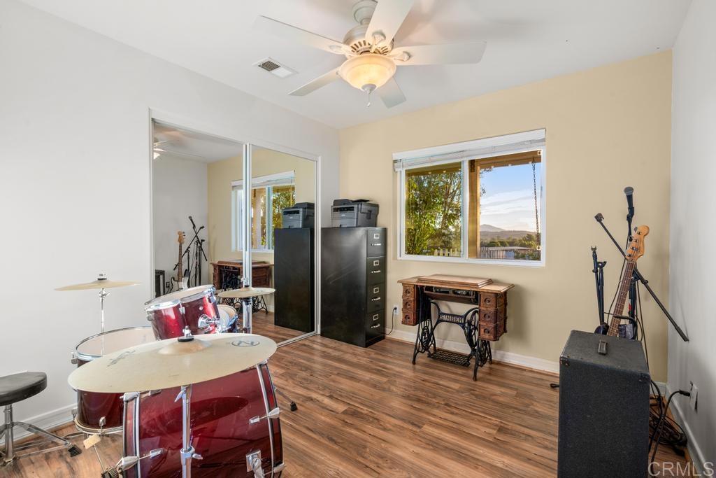 2043 Pamo Road Ramona, CA 92065 - Photo 22 of 63 a view of a dining room with furniture window and wooden floor