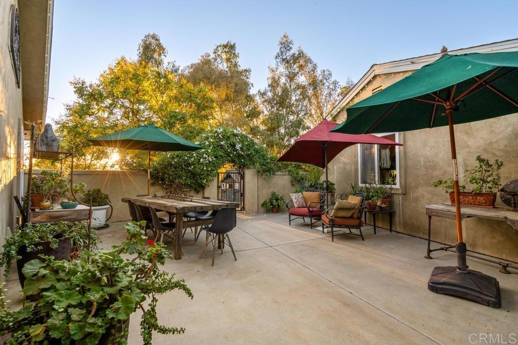 2043 Pamo Road Ramona, CA 92065 - Photo 28 of 63 a view of patio with chairs and table under an umbrella