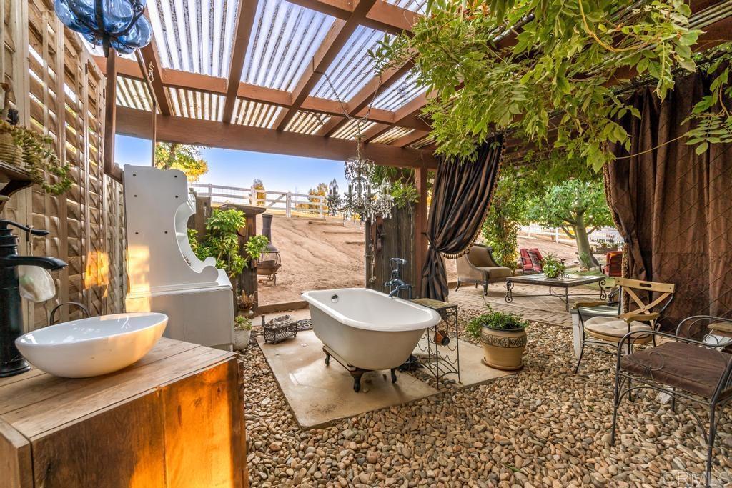 2043 Pamo Road Ramona, CA 92065 - Photo 32 of 63 a view of a patio with couple of chairs and potted plants