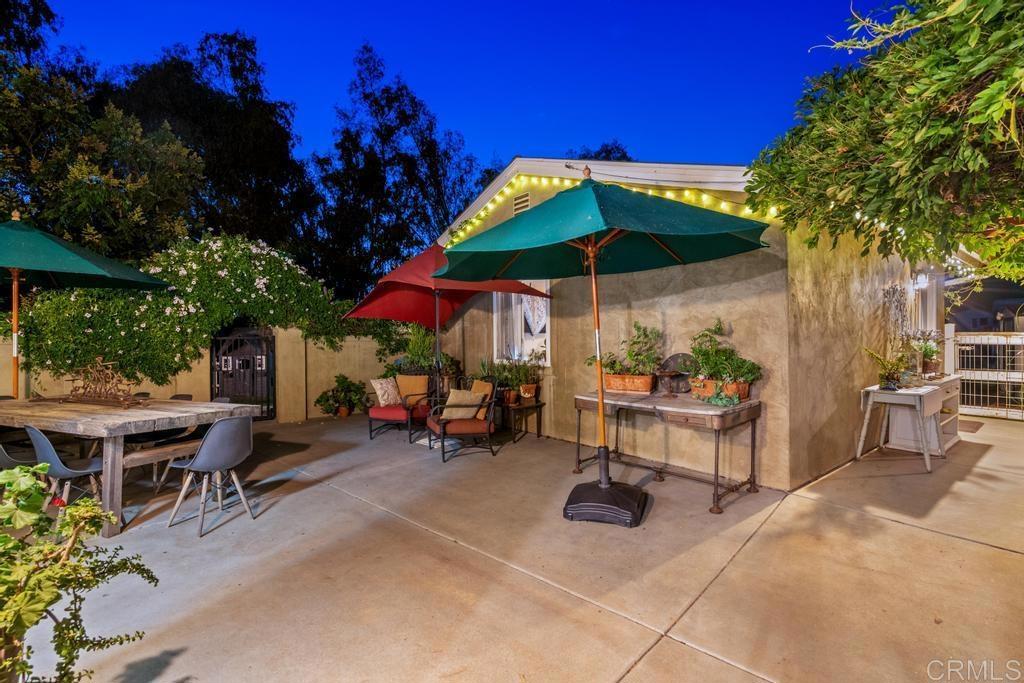 2043 Pamo Road Ramona, CA 92065 - Photo 54 of 63 a view of a tables and chairs under an umbrella in patio