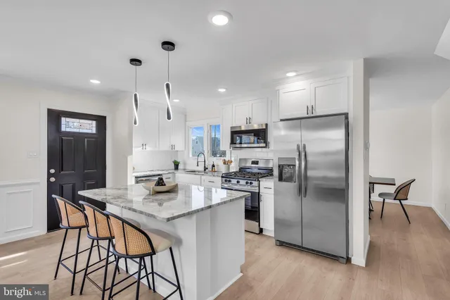 a living room with furniture and kitchen view